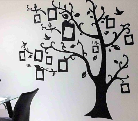 Decoración con vinilos personalizados de corte de un arbol en una sala de una casa sobre una pared blanca y árbol negro 